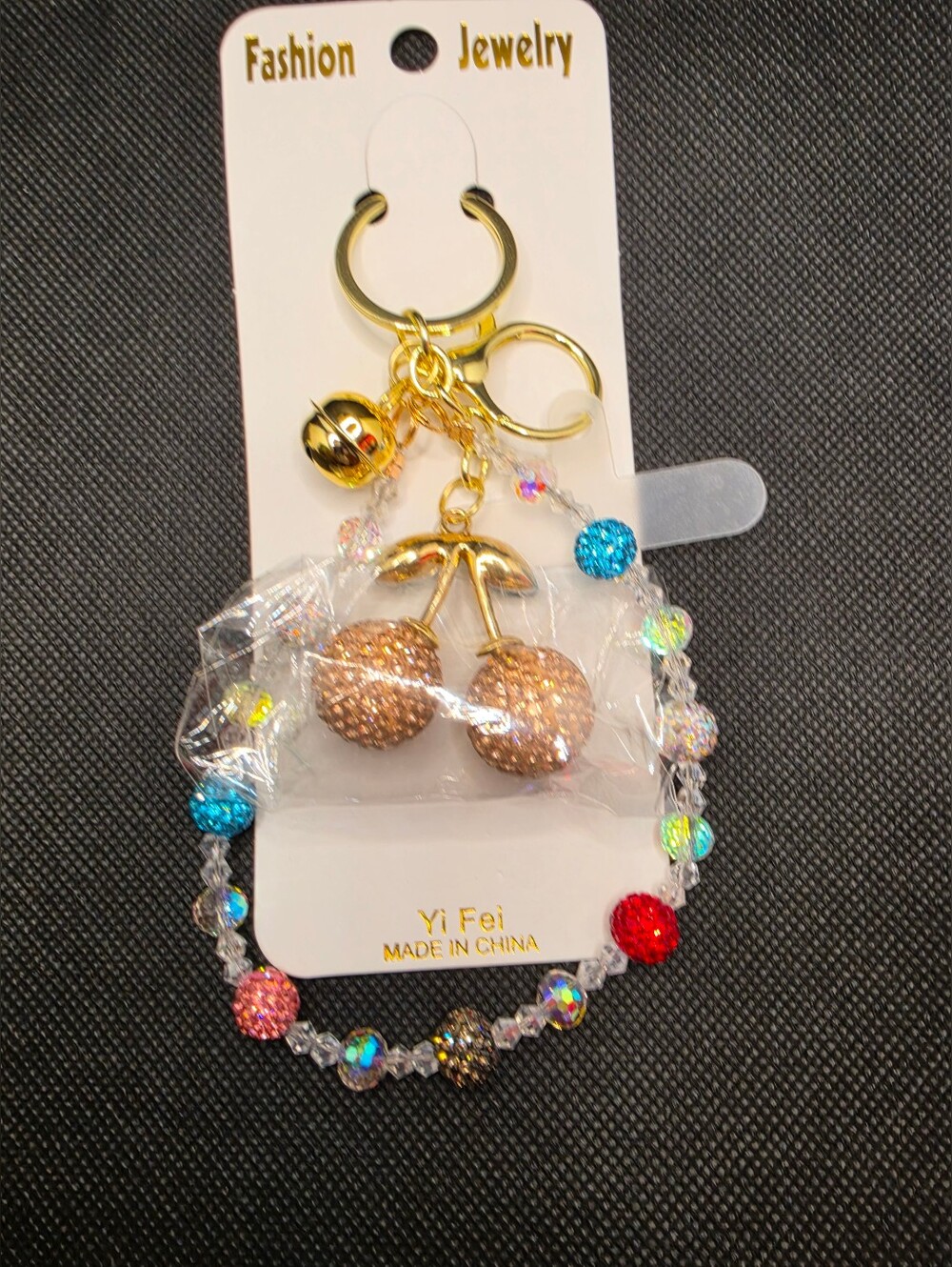 Gold Cherry Keychain with Multicolor Beaded Design.